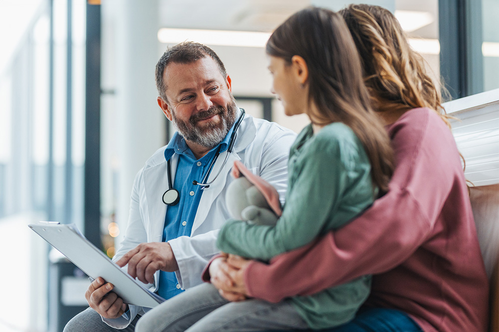 Doctor talking to a mother and daughter. Doctor talking to a mother and daughter.