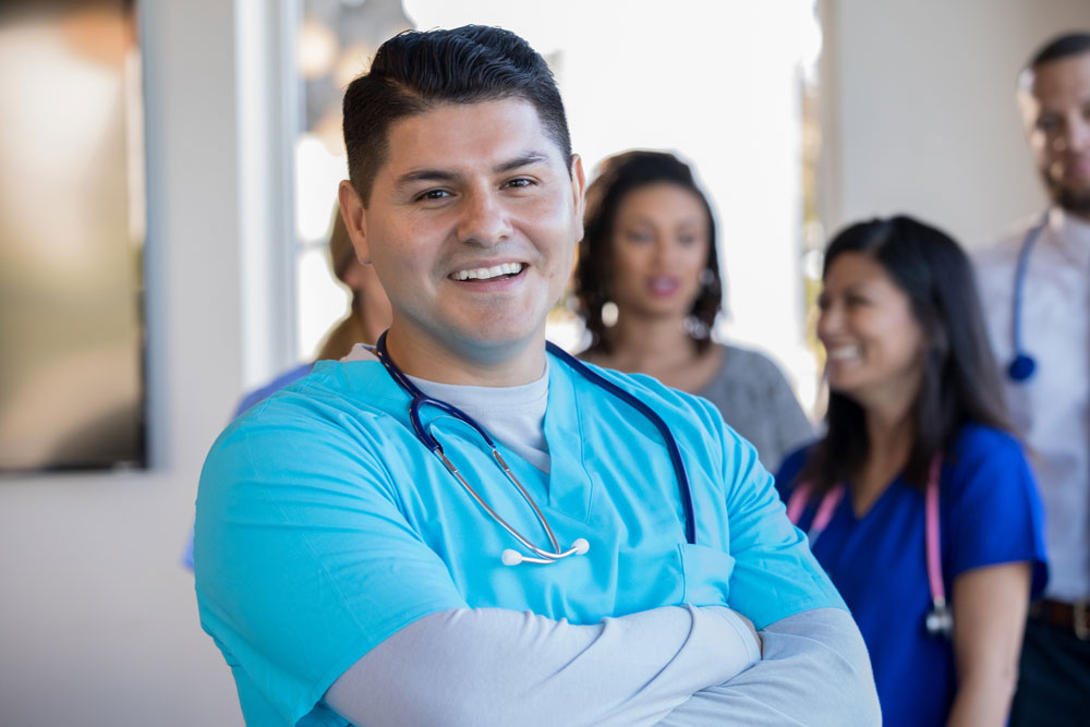 Male Hispanic health care worker. Male Hispanic health care worker.