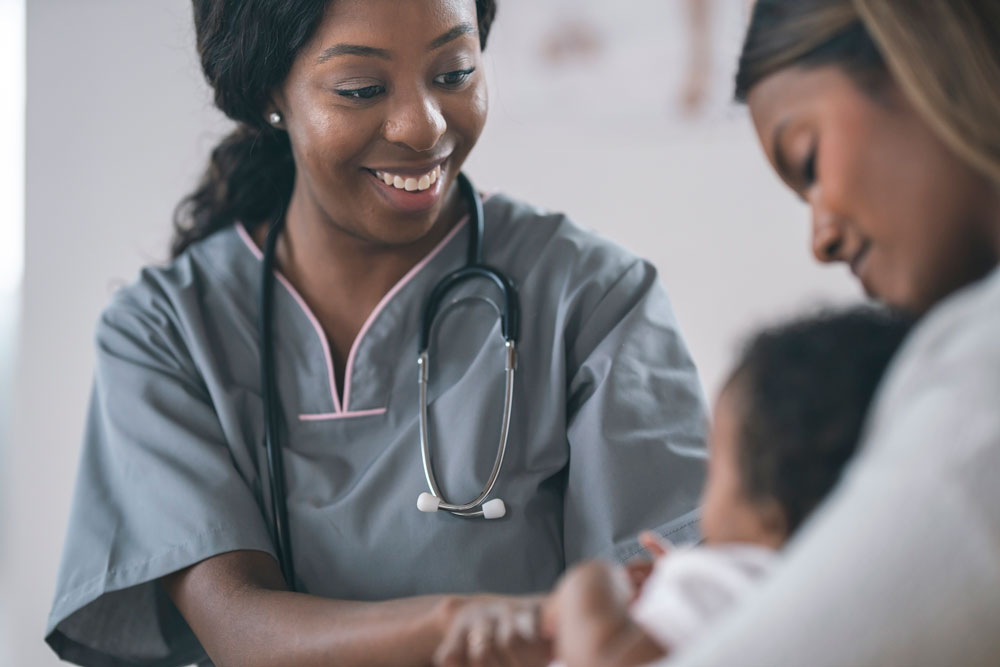 A nurse with mom and baby.