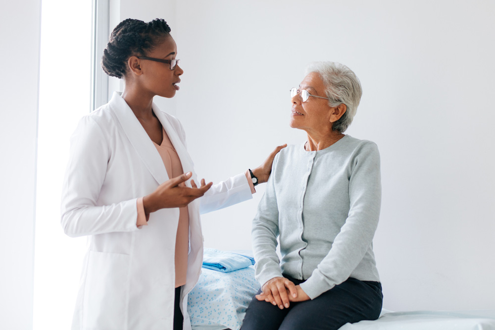 Woman doctor talking to an elderly woman patient. Woman doctor talking to an elderly woman patient.