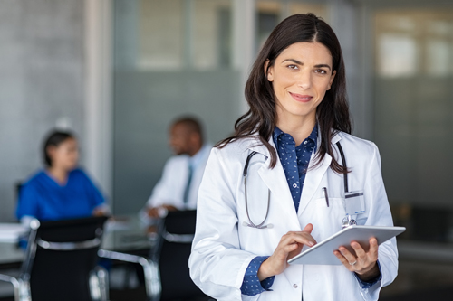 Woman doctor holding an iPad.